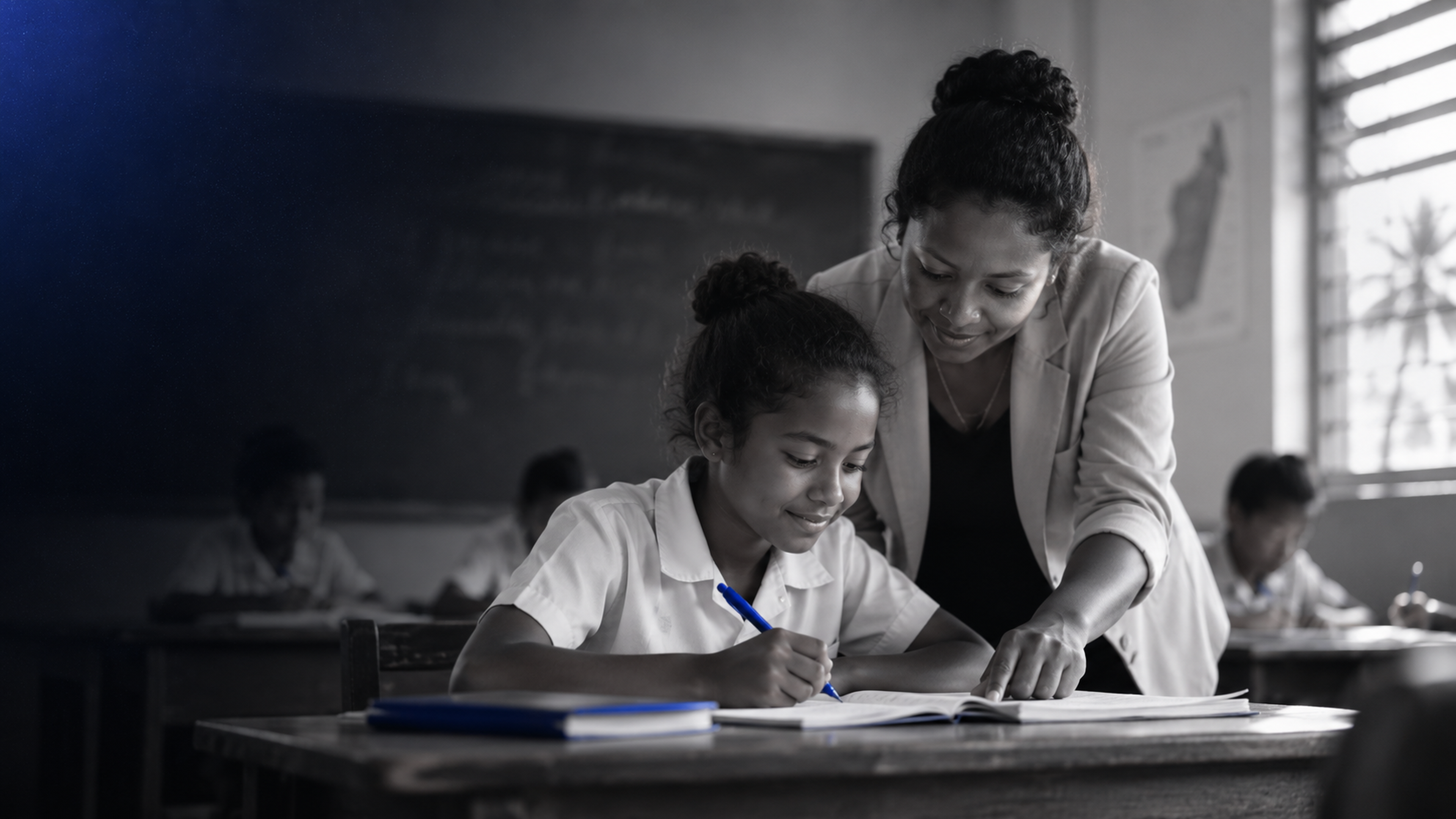 Une enseignante accompagne un élève dans son travail en classe